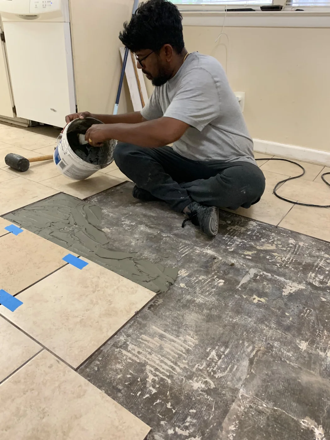 Dad preparing mortar during the same tile floor project, work in progress